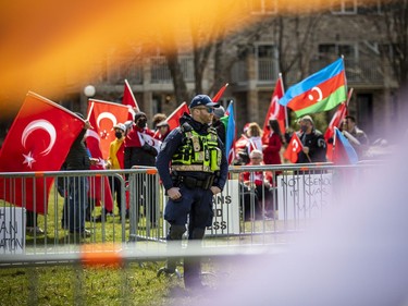 A small group of counter-protesters were on site Sunday, separated from the Armenian supporters by metal fences and police.