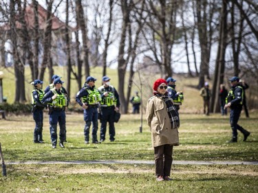 A woman, unconnected to the protest, stood back watching as police filled the park.