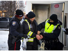 Police clear out the remaining 'Freedom Convoy'  protesters who were set up in a parking lot on Coventry Road on Feb. 20, 2022.