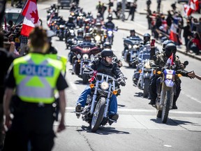 The 'Rolling Thunder' Ottawa motorcycle rally makes its way through downtown Ottawa on a controlled route along Elgin Street on Saturday, April 30, 2022.