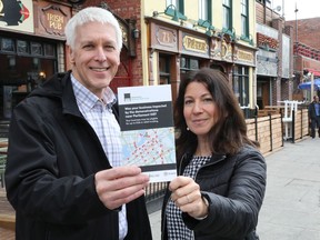 Michael Tremblay, left, CEO of Invest Ottawa, and Michelle Groulx, executive director of the Ottawa Coalition of Business Improvement Areas, hand out flyers about he Downtown Ottawa Business Relief Fund in the ByWard Market on Tuesday.