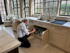 Alan Carson, a co-founder of CHIC, is seen here inspecting plumbing fixtures in a kitchen. Home buyers, who opt to wave a full home inspection, he says, are potentially putting themselves at risk.