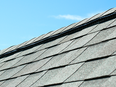 The raised area at the peak of this roof is a ridge vent. It provides the most passive attic ventilation with the least visual disruption of the roof surface.