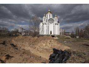 BUCHA, UKRAINE: Bodies lie inside a mass grave by a church on April 4, 2022 in Bucha, Ukraine. The Ukrainian government has accused Russian forces of committing a 'deliberate massacre' as they occupied and eventually retreated from Bucha, 25 km northwest of Kyiv.