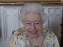 Queen Elizabeth II speaks to NHS Key workers via video call to hear about their experiences of working on the front line during the pandemic to mark the official opening of the hospital's Queen Elizabeth Unit on April 06, 2022 in London, England. 