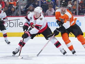 Brady Tkachuk (7) of the Ottawa Senators controls the puck against Noah Cates (49) of the Philadelphia Flyers in the third period at the Wells Fargo Center on April 29, 2022 in Philadelphia, Pennsylvania.