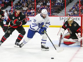 Colin Blackwell (11) of the Toronto Maple Leafs battles for the puck with Nick Holden (5) of the Ottawa Senators during the third period at Canadian Tire Centre on April 16, 2022.