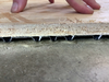: This cutaway view of a basement subfloor panel shows how the plastic bottom layer elevates the tile, providing room for a small amount of leaked water to drain away harmlessly.