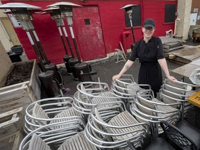 Absinthe Cafe sous-chef Jess Craig in the restaurant's rear patio, yet to be set up for the spring-summer season, on Friday.