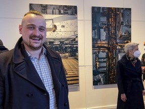 Second year graduate student Justin M. Millar with two of his artworks at the Ottawa School of Photographic Arts.