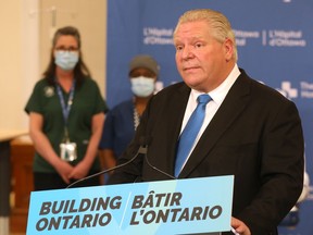 A maskless Premier Doug Ford makes a funding announcement at The Ottawa Hospital on March 25.