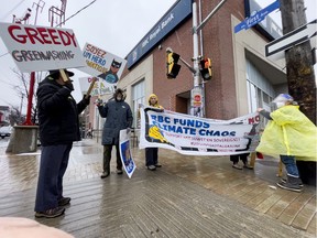 Extinction Rebellion Ottawa protestors Mike Benedict, Eric Schiller, Linda McCourt, and Cecile Wilson, at a RBC branch on Bank Street on Thursday.