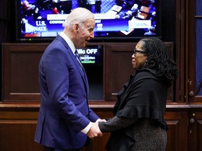 U.S. President Joe Biden holds hands with Supreme Court nominee Judge Ketanji Brown Jackson as they watch the full U.S. Senate vote on Jackson's nomination to the U.S. Supreme Court, from the Roosevelt Room at the White House in Washington, U.S., April 7, 2022.