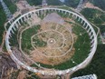 This picture taken on July 29, 2015 shows the five-hundred-metre Aperture Spherical Radio Telescope (FAST) under construction in Pingtang, China. Scientists intend for this telescope and another in northern California to transmit the message.