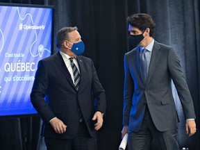 Quebec Premier François Legault, left, and Prime Minister Justin Trudeau chat after they announced high speed internet for Quebec regions, on March 22, 2021 in Trois-Rivieres Que.