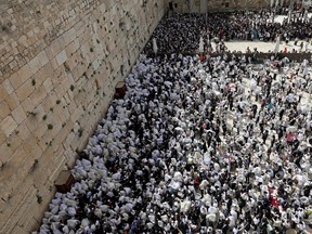 Jewish worshippers pray during the Passover holiday at the Western Wall in Jerusalem's Old City on April 18, 2022.