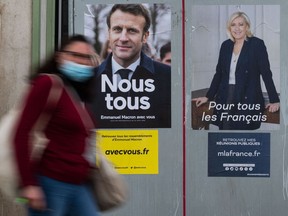 Electoral campaign posters for Emmanuel Macron (L) and Marine Le Pen in Savenay, western France. The run-off vote for the French presidency is this weekend.