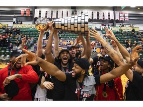 Carleton Ravens players celebrate the win over the Saskatchewan Huskies during the U Sports Men's Final 8 Basketball Championship gold-medal game in Edmonton last Sunday.