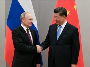 China's Xi Jinping, right, has clearly shown he has the same ruthless character as Russian President Vladimir Putin.