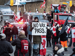 People gather around trucks near the Ontario legislature in Toronto to protest COVID-19 mandates on February 5, 2022.