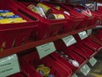 File photo: Donated goods are sorted in red baskets at the Ottawa Food Bank's warehouse.