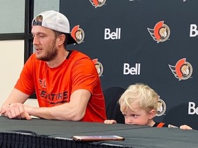 FILES:  While his son, Ben, looks on, Ottawa Senators goaltender Anton Forsberg speaks to the media following his team's 4-0 victory against the Tampa Bay Lightning in a National Hockey League game at Ottawa on Saturday, Dec. 11, 2021.