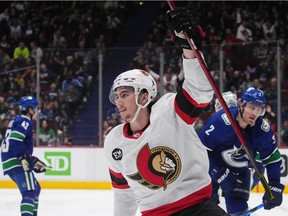 Ottawa Senators' Alex Formenton celebrates his goal as Vancouver Canucks' Luke Schenn (2) looks on during the third period of an NHL hockey game in Vancouver, B.C., Tuesday, April 19, 2022.
