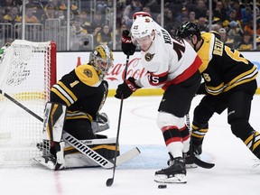 Ottawa Senators left wing Parker Kelly (45) looks to gain control of the puck in front of Boston Bruins goaltender Jeremy Swayman (1) during the second period at TD Garden, April 14, 2022.