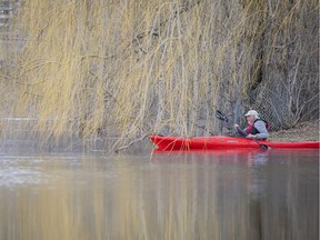 OTTAWA -- The Rideau River was flowing at a high level near Brantwood Park off Clegg Street Saturday, April 9, 2022. A paddler pushed off from shore into the Rideau River, through the willow trees Saturday afternoon.