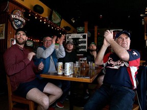 Carter Hoffman, Lester Webb, Luke Webb, Enzo Romeo and Brent Hoffman watch Matt Brash make his Major League Baseball debut for the Seattle Mariners, pitching against the Chicago White Sox, at the Brass Pub in Kingston on Tuesday.