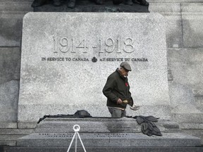 Elder Albert Dumont leads a smudging of the National War Memorial at Saturday's ceremony commemorating the 105th anniversary of the Battle of Vimy Ridge.