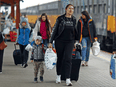 Ukrainian refugees arrive at a train station in Przemysl, Poland, after fleeing the Russian invasion of Ukraine.