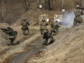 Ukrainian servicemen of the 103rd Separate Brigade of the Territorial Defense of the Armed Forces take part in a training exercise, as Russia's invasion of Ukraine continues, near Lviv, Ukraine, March 29, 2022.