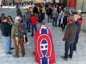 Canadiens fans wait outside the Bell Centre on May 1, 2022, to pay tribute to Guy Lafleur