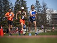 The Bytown Walkers Club held its 15th annual speed walking races at Terry Fox Stadium on Sunday, May 8, 2022. From left: Jianping Xu, Yvan Bechard, and Martin Archambault compete in the Canadian One Hour race Sunday.