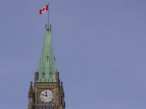 The Canadian flag flies atop the Peace Tower on Centre Block of the Parliament Buildings on Wednesday, Mar. 10, 2021.