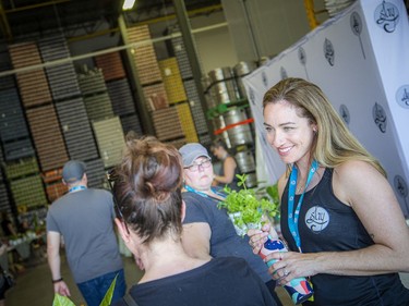 Laura Dill (right), along with a team of volunteers chanced the weather and held a very successful fundraising plant sale at Broadhead Brewing Company in the city's east end, Sunday, May 15, 2022.
