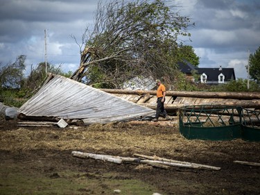Matt LaRose checks out the damage to one of the buildings on the farm in White Lake, Monday, May 23, 2022.