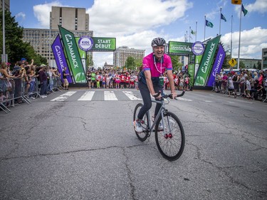 Ian Fraser, executive director of Run Ottawa and Race Director for Tamarack Ottawa Race Weekend, goes the two-wheel route before starting out as lead pacer for the Kids Marathon on Saturday.