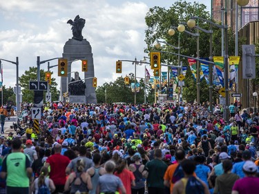 OTTAWA --  A group of runners make their way up the hill on Elgin Street, during their 5K race at Tamarack Ottawa Race Weekend, Saturday, May 28, 2022.