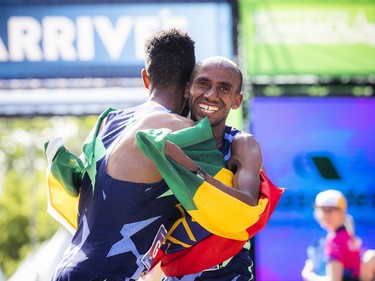 OTTAWA --  Abdi Ali Gelchu, second place finisher of the marathon, hugs winner, Andualem Shiferaw, at Tamarack Ottawa Race Weekend, Sunday, May 29, 2022.