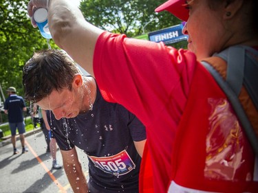 OTTAWA --  Nick Chadwick has water poured over his head at the finish line of the marathon at Tamarack Ottawa Race Weekend, Sunday, May 29, 2022.