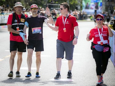 OTTAWA --  Doug Alexander finishes the marathon with a little help from medical helpers at Tamarack Ottawa Race Weekend, Sunday, May 29, 2022.