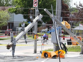 Crews are seen cleaning up on Merivale Road on May 25.