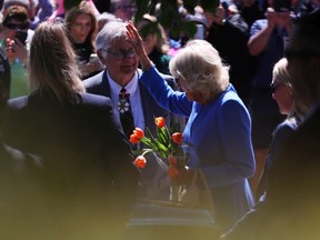 The Duchess of Cornwall is waving to the crowd after attending the National War Memorial ceremony in Ottawa on May 18, 2022.