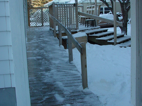 This residential access ramp shows how mobility features can be worked into porches and verandah’s that include steps. The side-to-side orientation of the ramp boards boosts traction and drainage.
