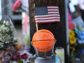 BUFFALO, NEW YORK - MAY 15: A makeshift memorial continues to grow outside of Tops market on May 15, 2022 in Buffalo, New York. A gunman opened fire at the store yesterday killing ten people and wounding another three.