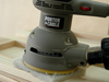 An ordinary random orbit sander on top of an abrasive pad delivers effective buffing action and a glass-smooth finish.