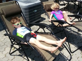 Twins Erin and Owen Robinson, age 5, enjoying the sun.