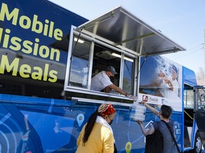 Chef Ric Watson gives hot meals from the Ottawa Mission's food truck on Tuesday, May. 10, 2022.